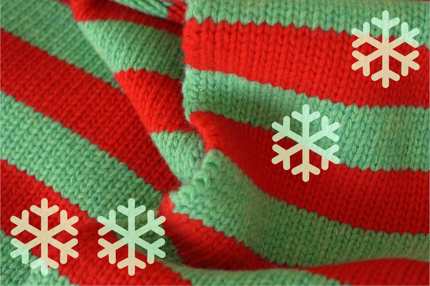 Close-up of red and green striped fabric with snowflake graphics