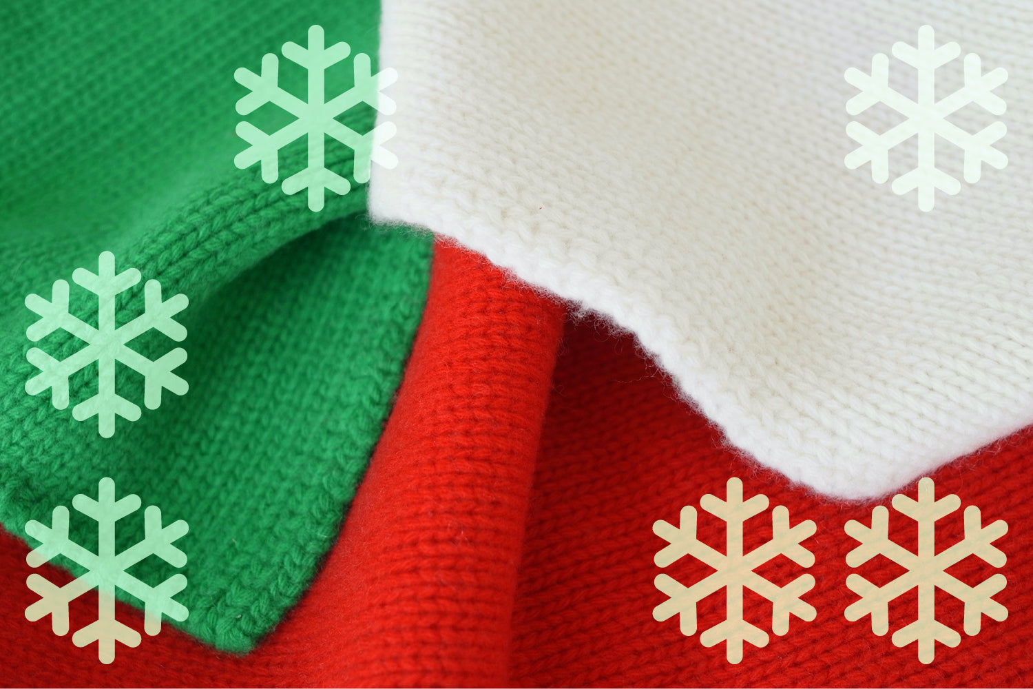 Close-up of a red, green, and white knitted fabric with snowflake patterns.