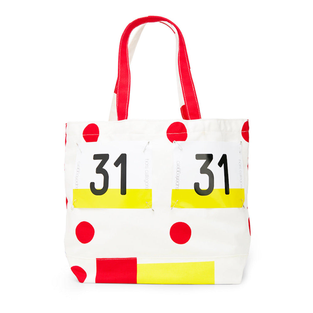 Tote bag with red polka dots, yellow stripes, and black numbers on a white background