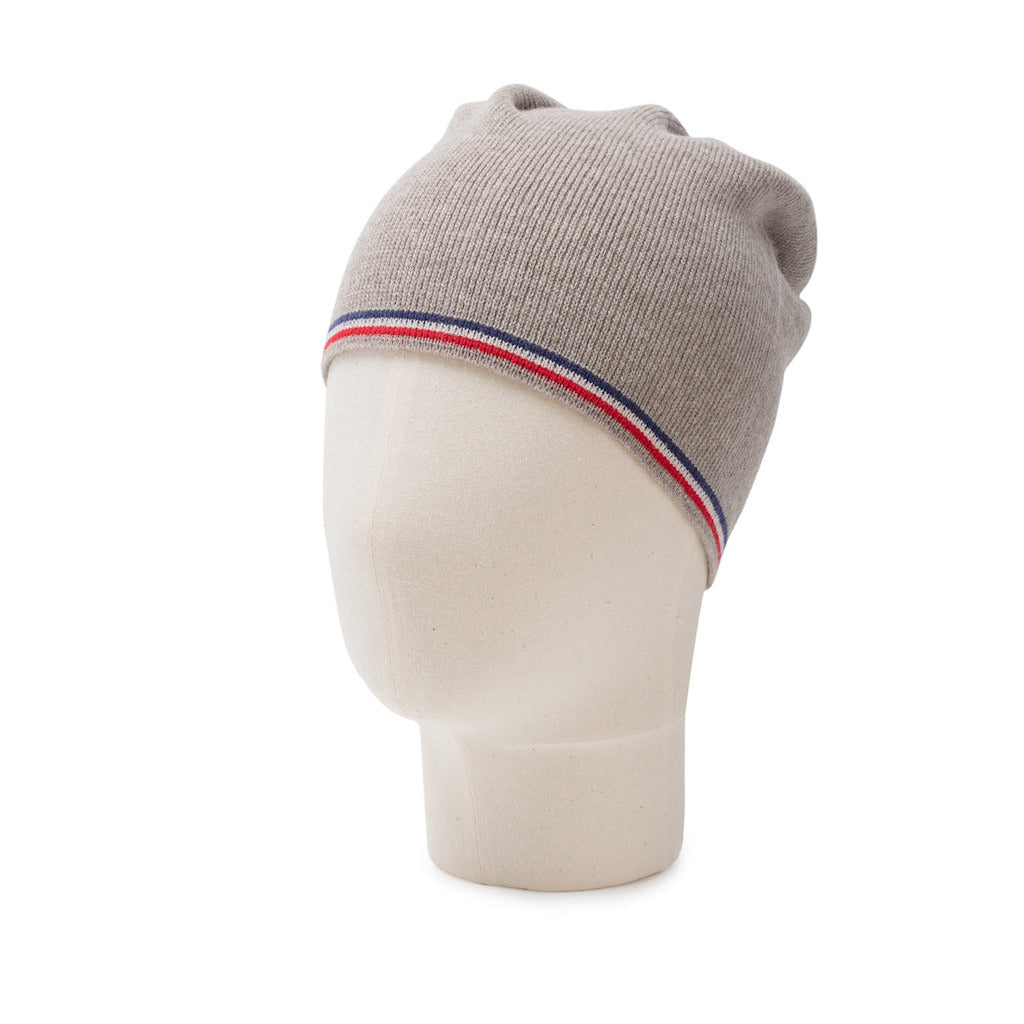 Beige knit snood with a striped band on a mannequin head against a white background