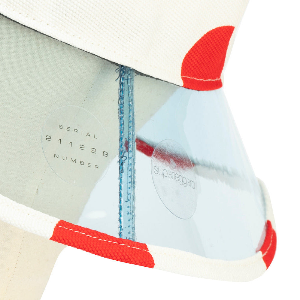 Close-up of a buckethat with red dots and 'Supeleggero' branding on a white background