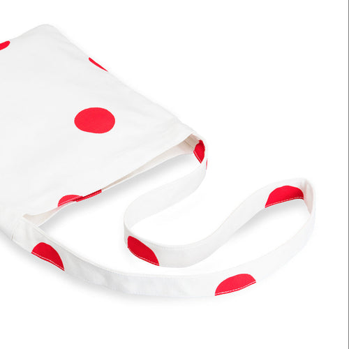 White fabric with red polka dots on a white background