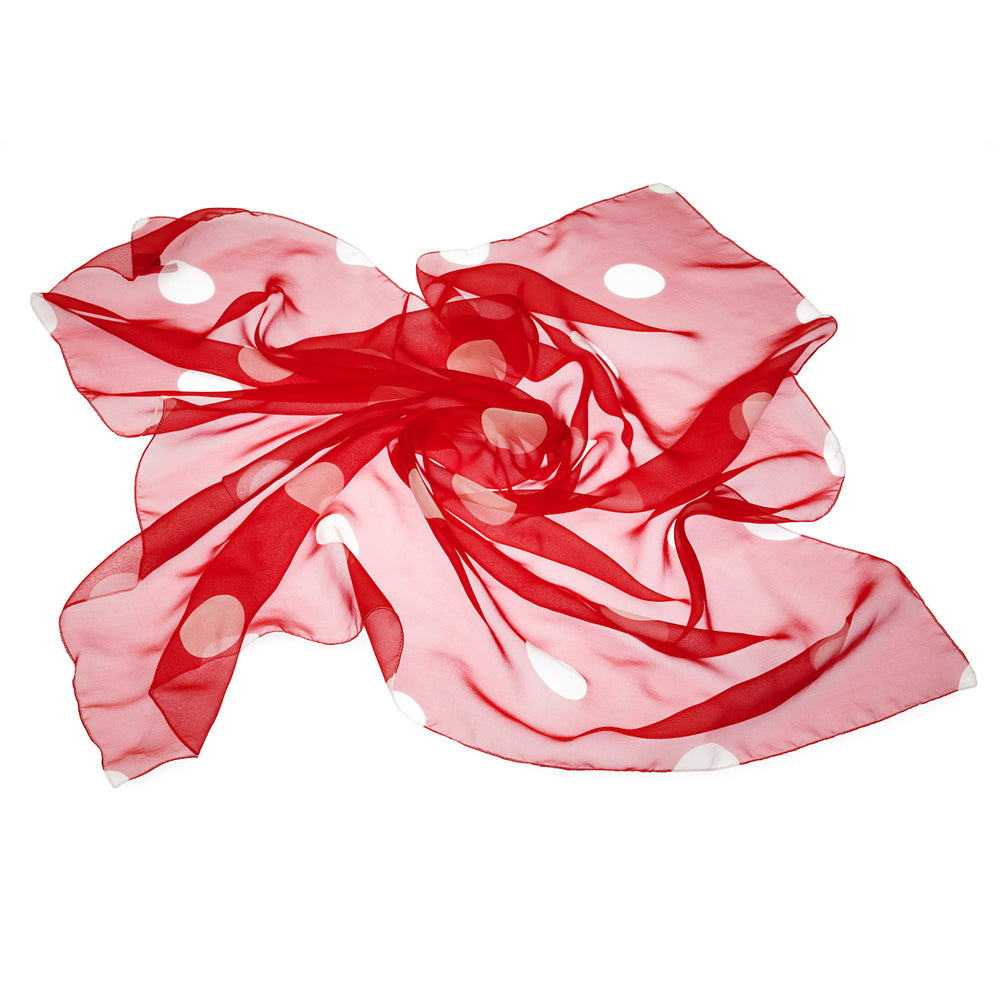 Red and white polka dot silk fabric on a white background