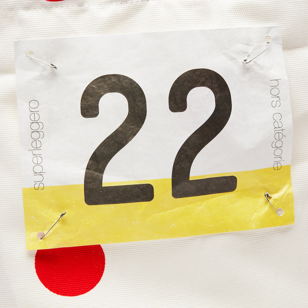 White tote bag with number 22 with red polkadots and yellow accents, featuring Superleggero branding.