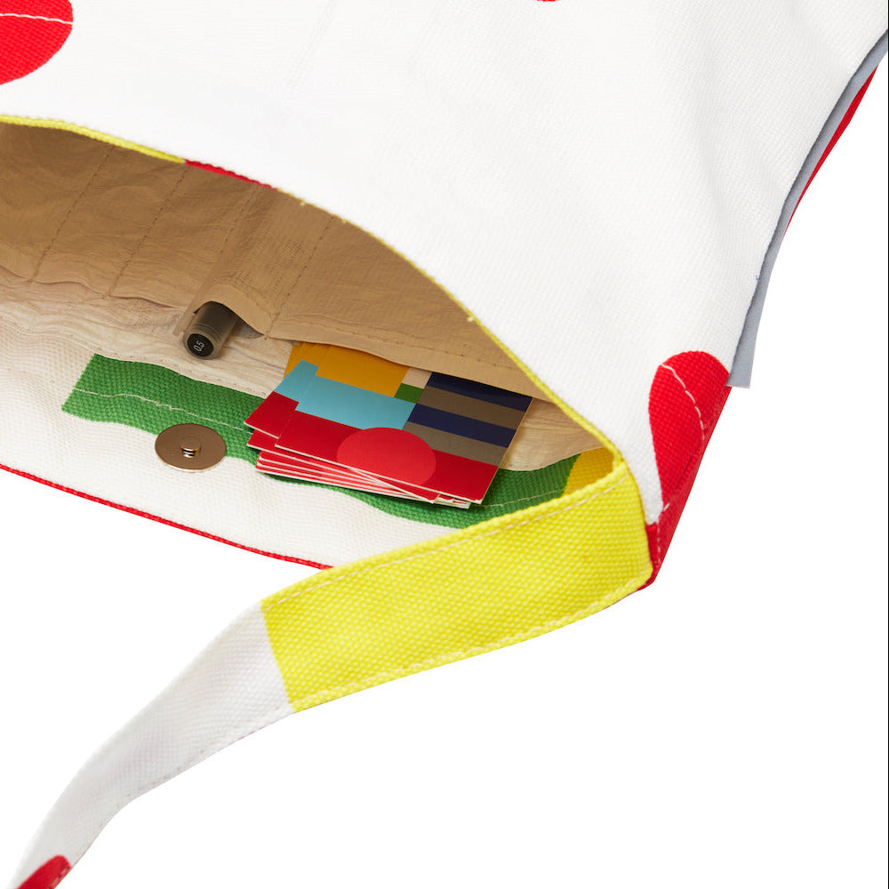 Colorful shoulderbag with a compartment for storing items on a white background
