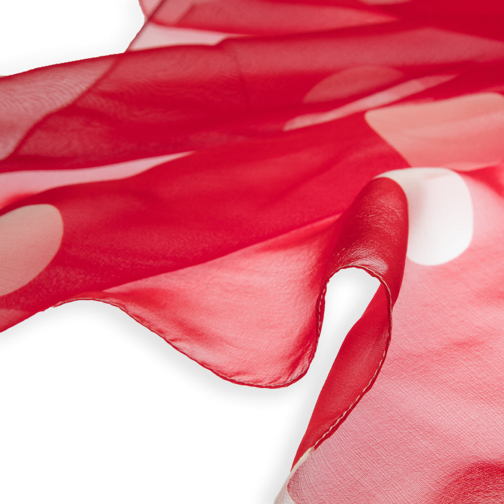 Red silk foulard with white polka dots on a white background